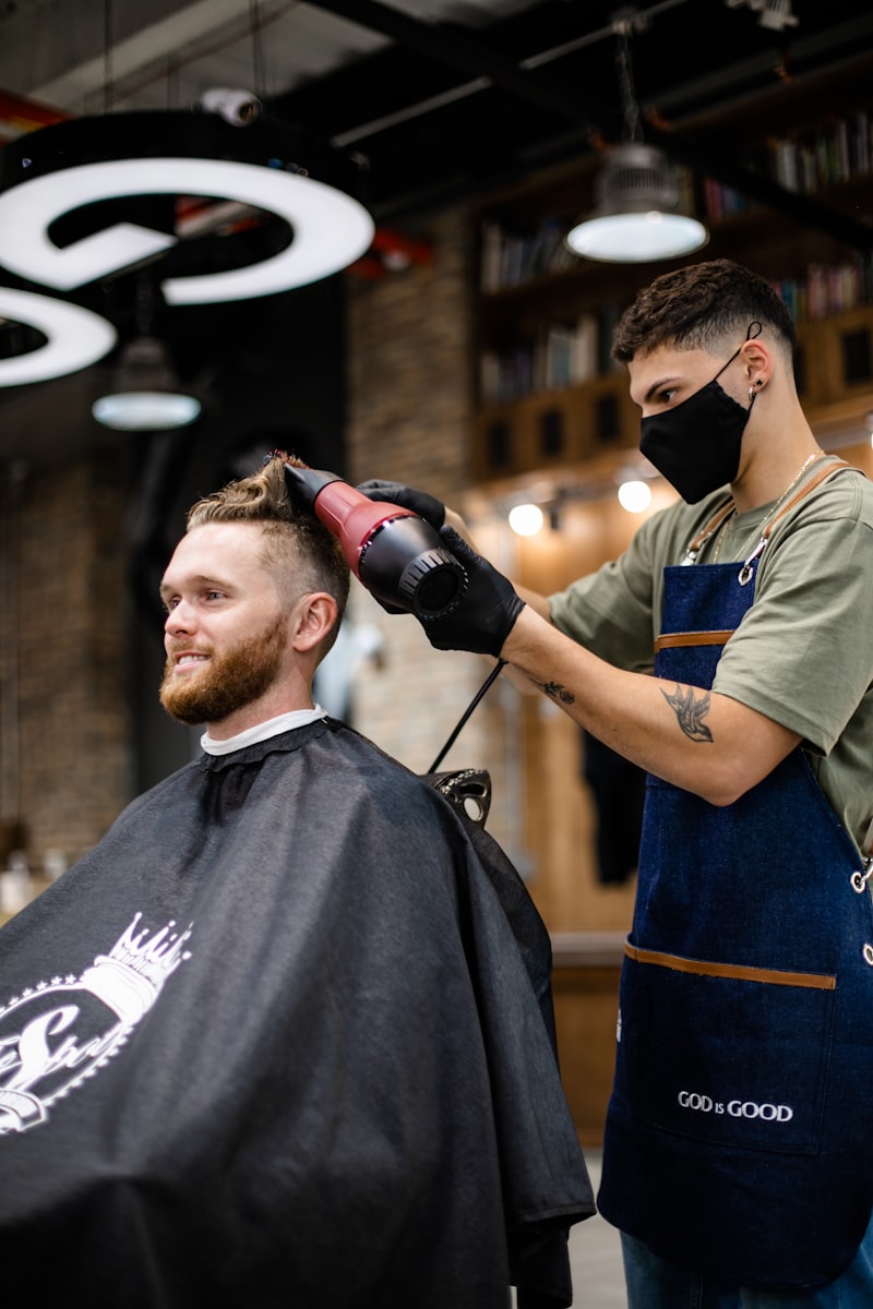 Barber working on a client's hair in a traditional barbershop